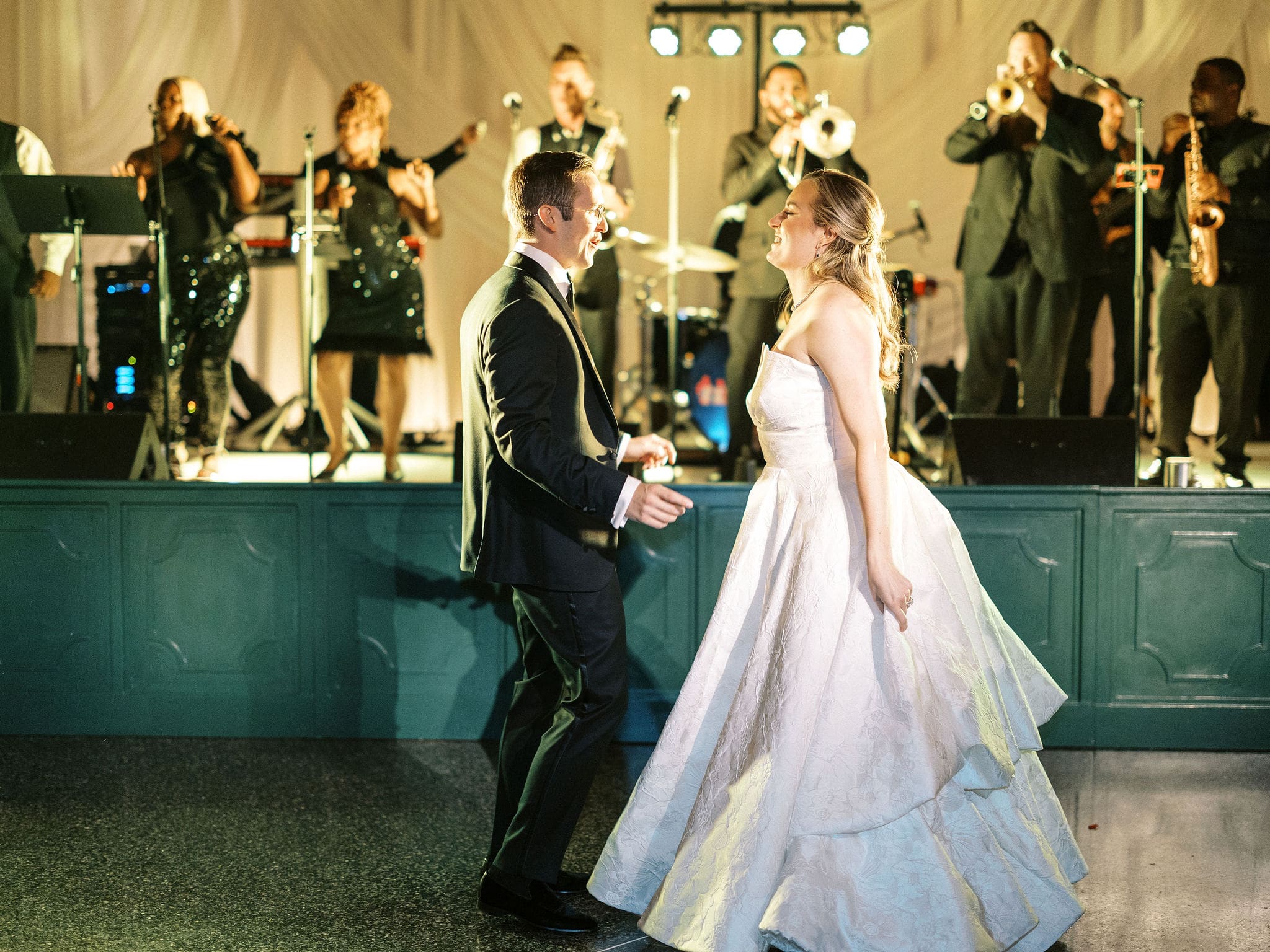 a bride and groom dancing on stage to FatPocket, photo taken by Trent Broglin Photography